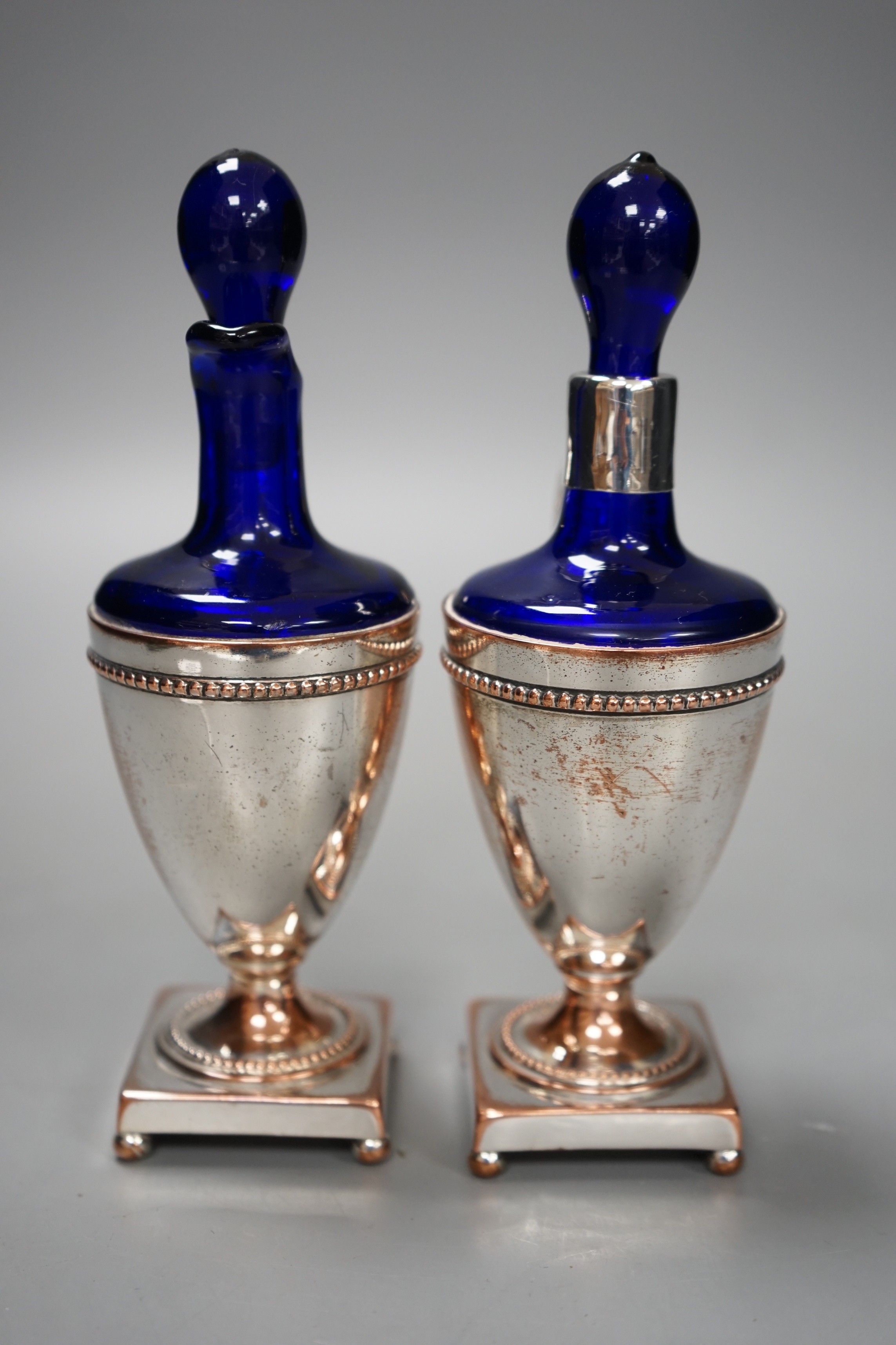 A pair of plate mounted blue glass scents, 16.5cm tall